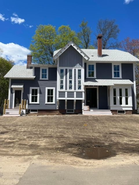 A large house with a lot of windows and a chimney