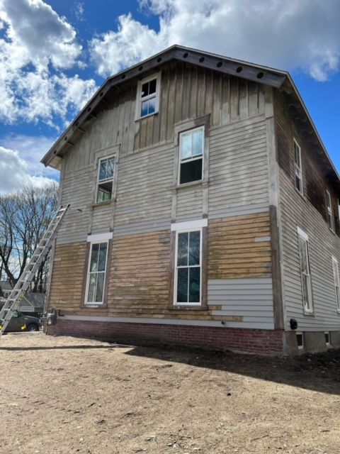 A large house with a ladder in front of it