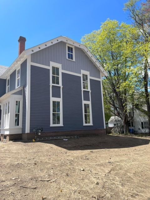 A blue and white house with a lot of windows