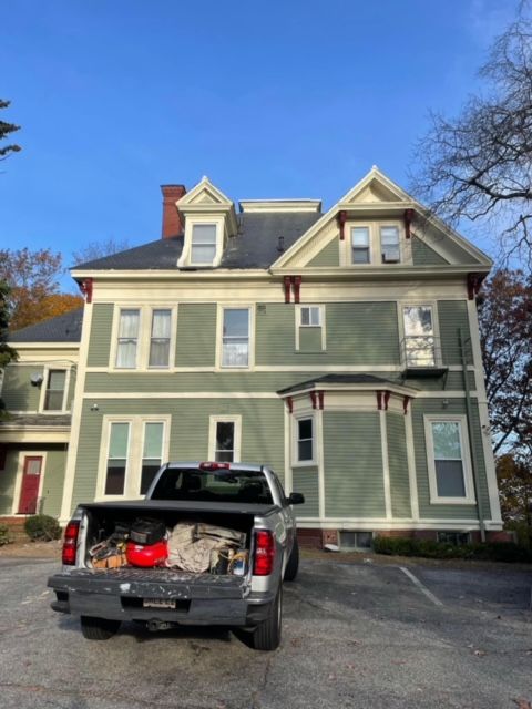 A large house with a truck parked in front of it