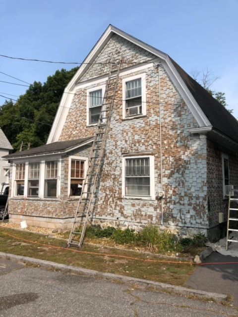 A house with a ladder on the side of it