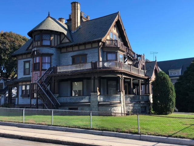A large house with stairs leading up to the second floor