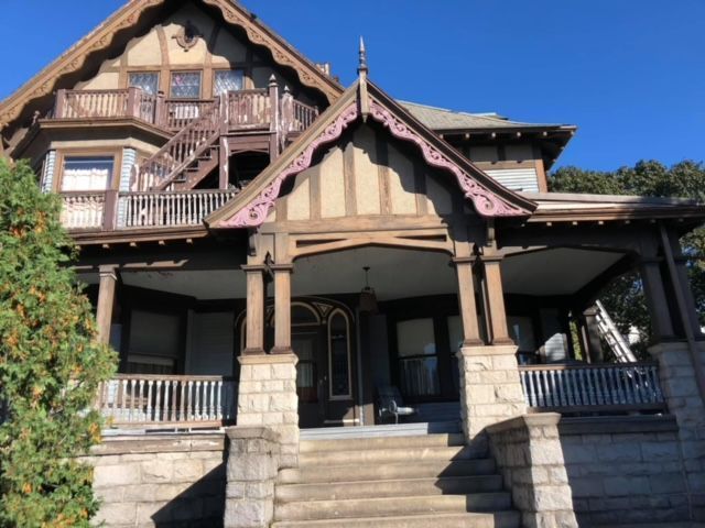 A large house with a large porch and stairs