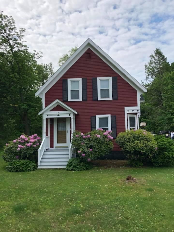 A red house with white trim and black shutters