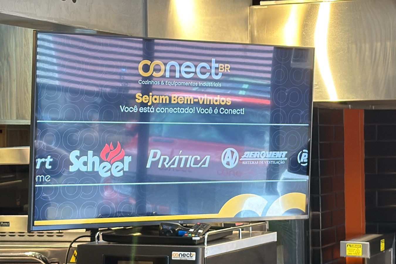 A television displaying business logos and text that reads,