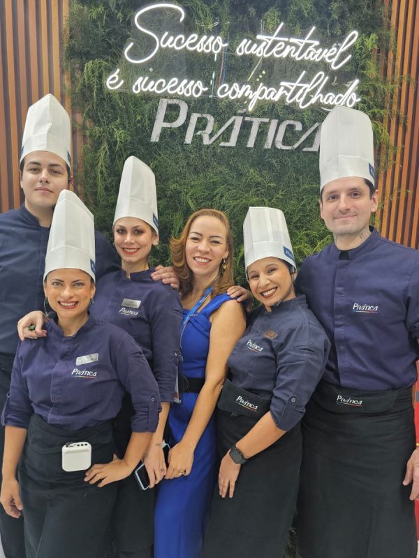 Um grupo de pessoas usando chapéus de chef posam para uma foto