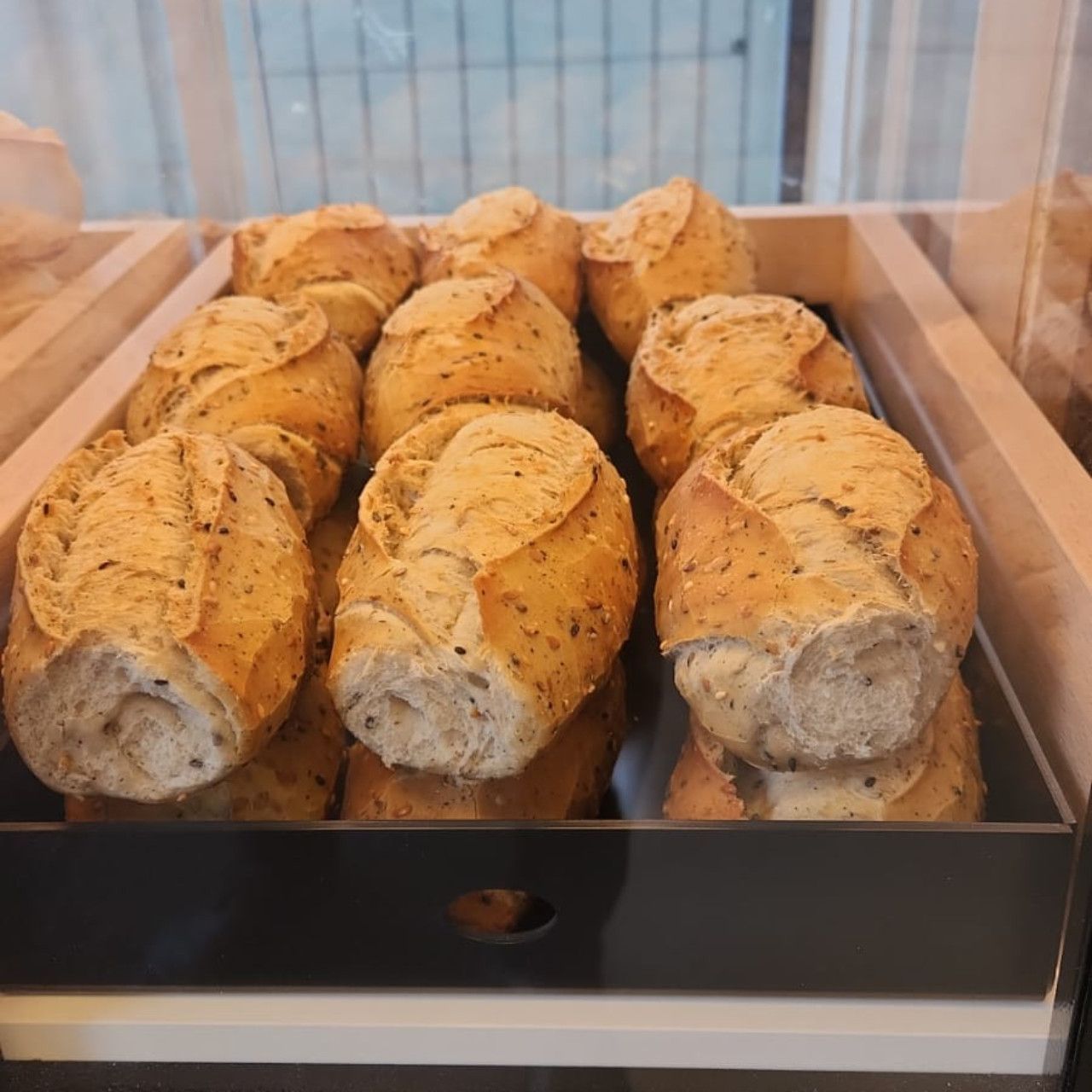 Um monte de pãezinhos em uma caixa de madeira