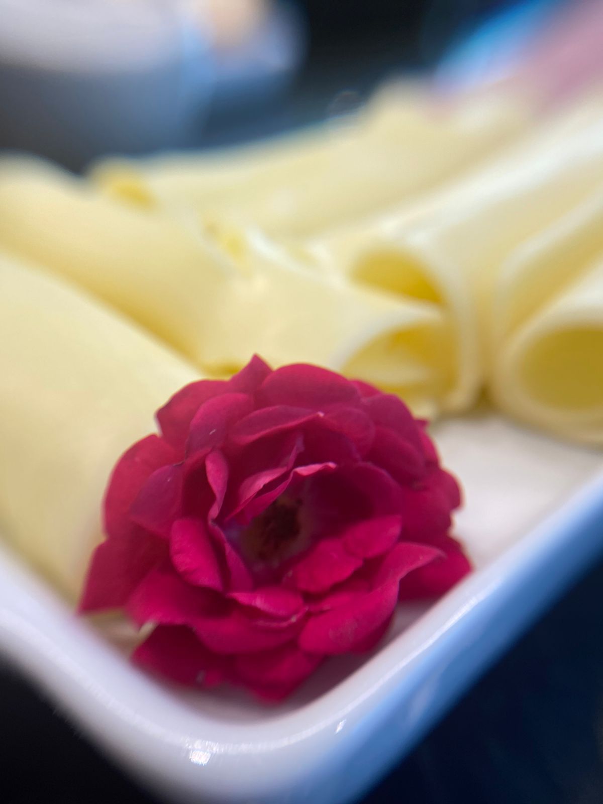 Um close de uma rosa vermelha em um prato de comida