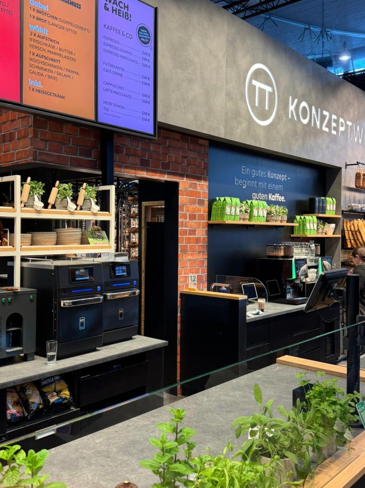 Um restaurante com uma parede de tijolos e uma placa que diz konzept.