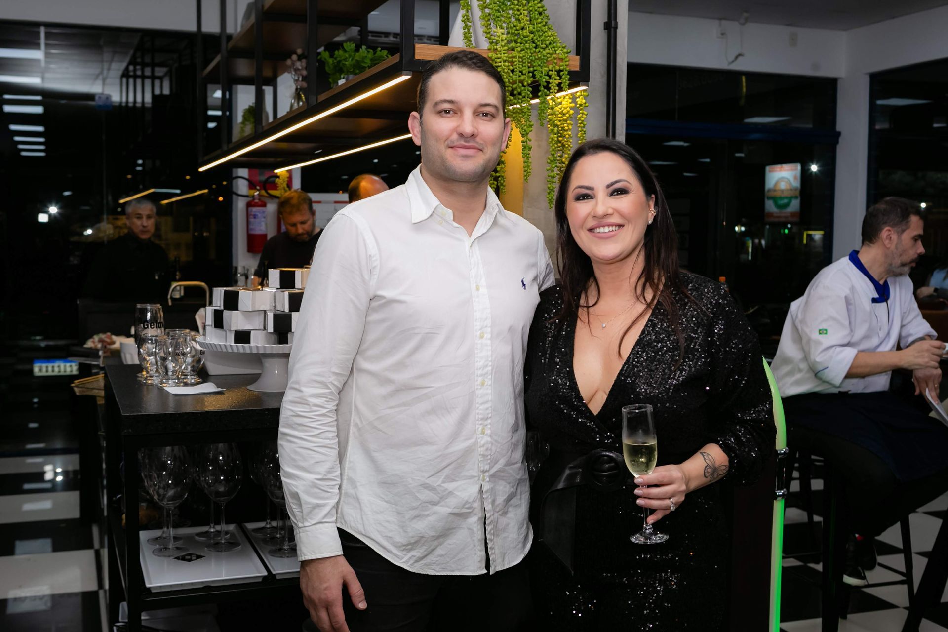 Um homem e uma mulher estão posando para uma foto em um restaurante.