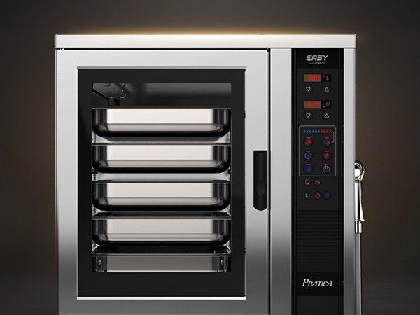 Um forno de convecção de aço inoxidável com três bandejas dentro dele.