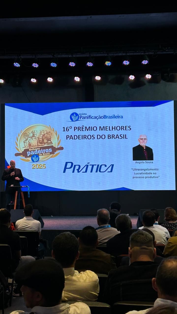 Man speaking at a conference. Screen reads: 