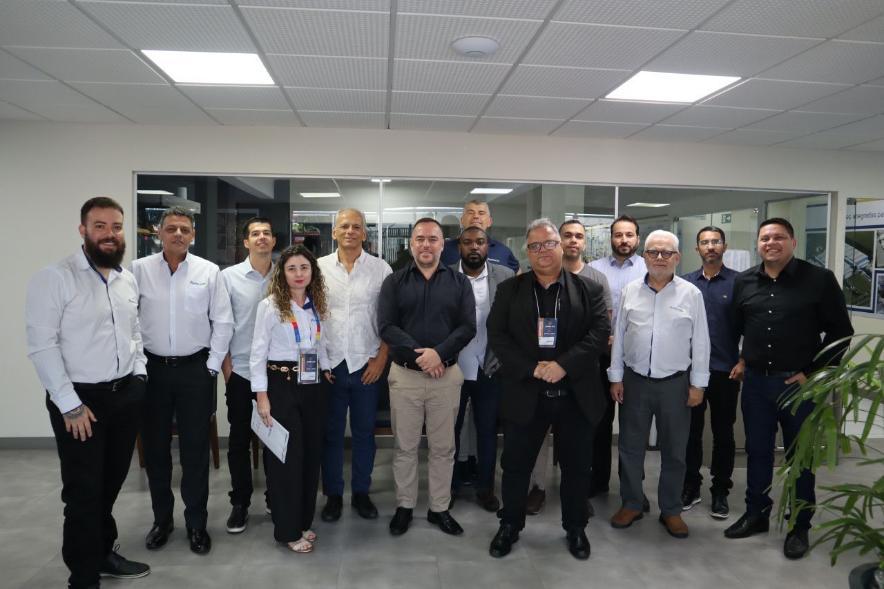 Um grupo de pessoas está posando para uma foto em uma sala.