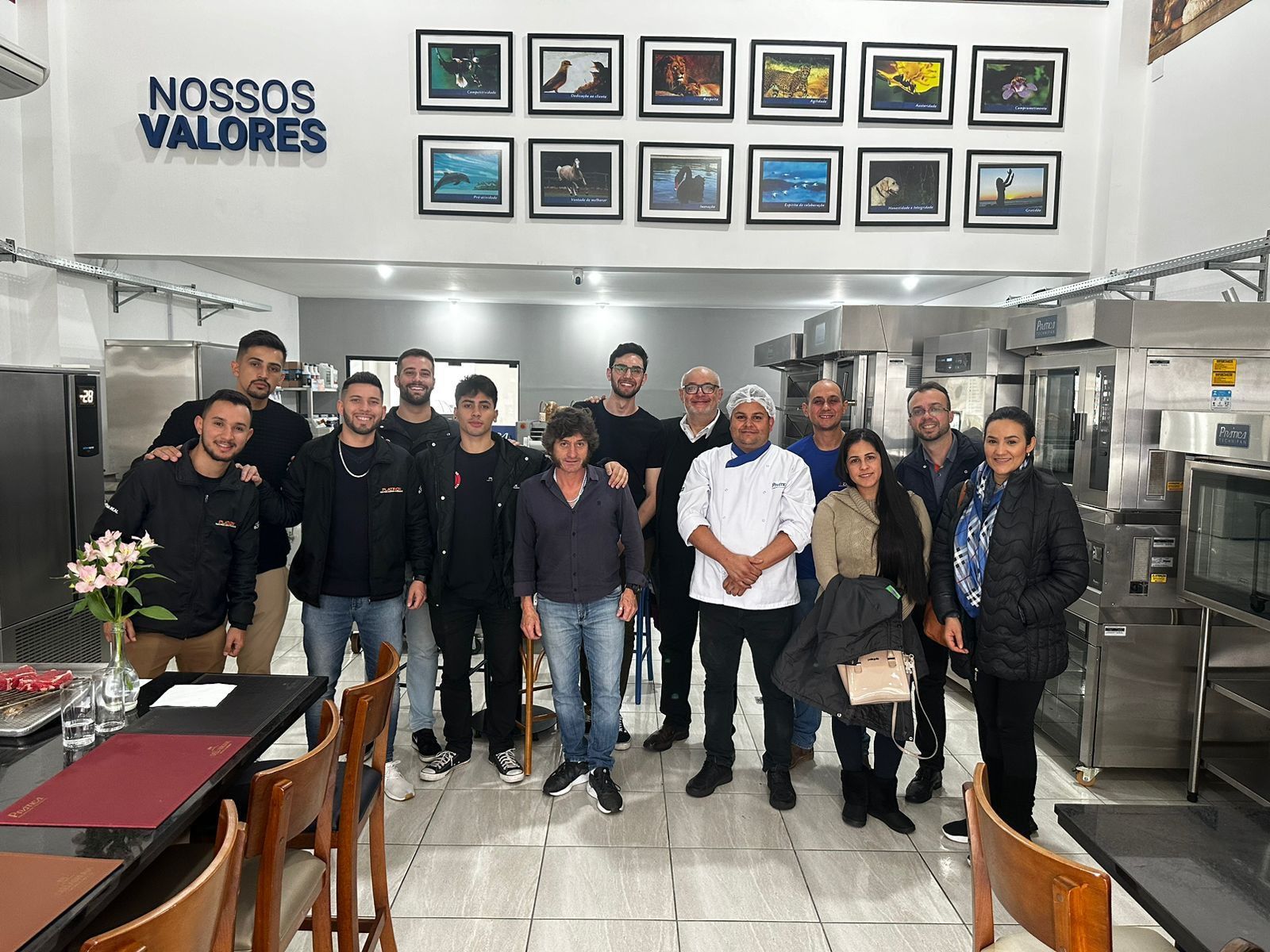 Um grupo de pessoas está posando para uma foto em um restaurante.