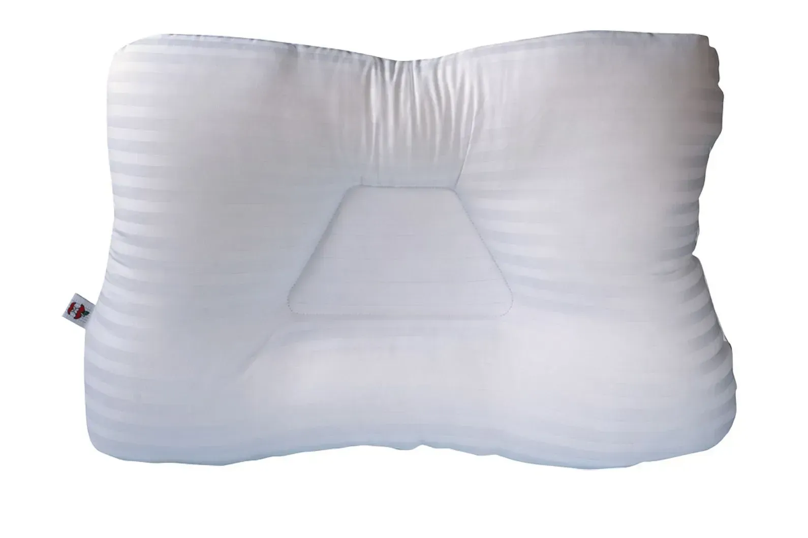 A white pillow is sitting on a white surface.