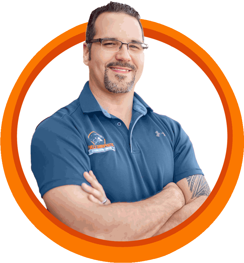 A man wearing glasses and a blue shirt is standing with his arms crossed in an orange circle.