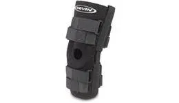 A black knee brace is sitting on a white surface.