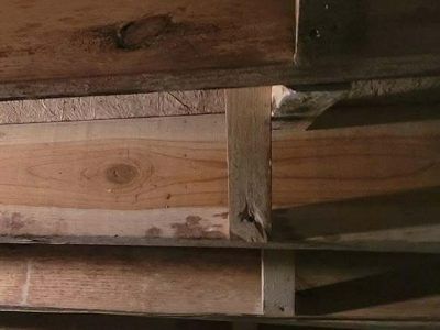 Wooden beams and supports in a close-up shot, showing construction details and wood grain.