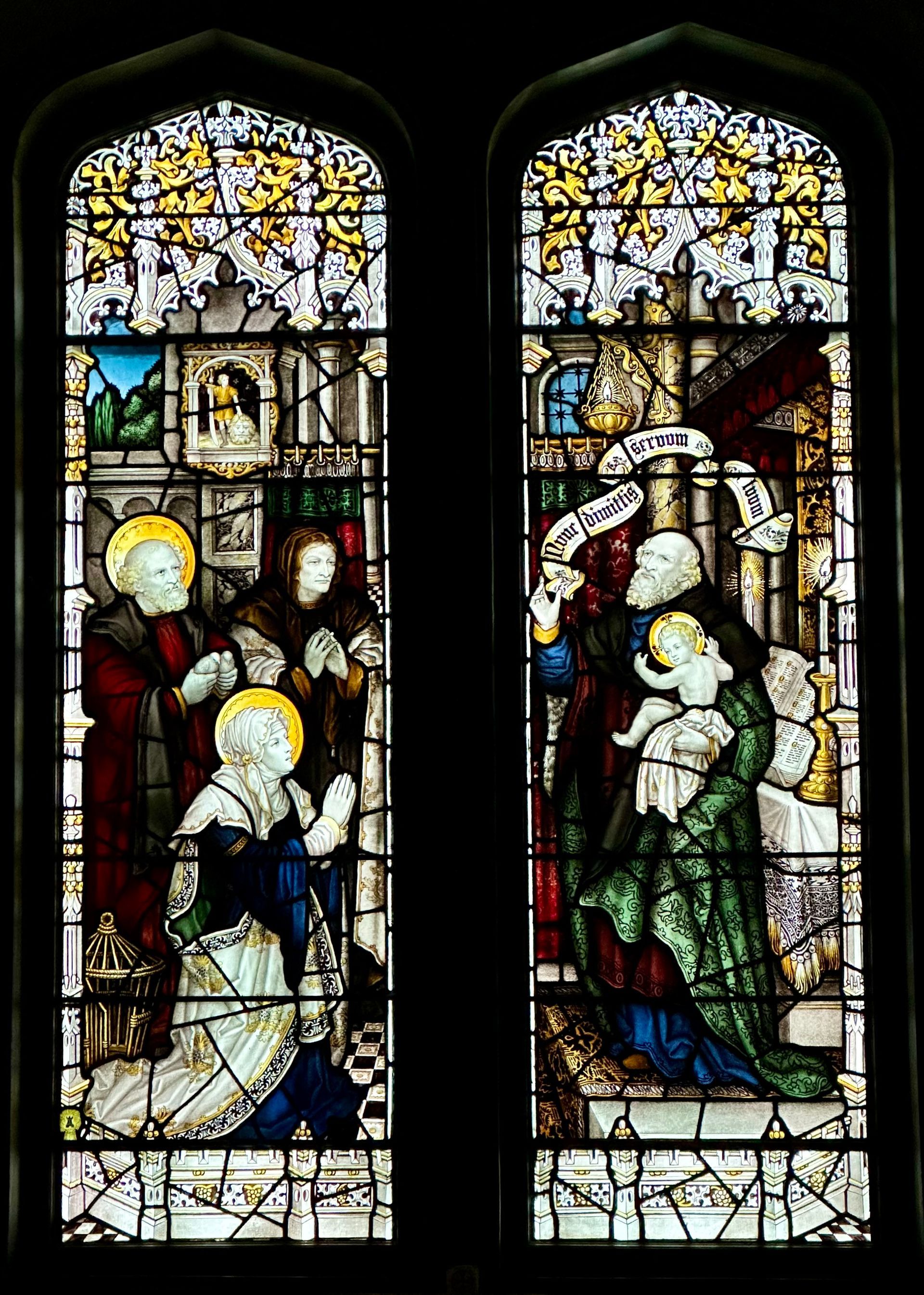 Stained glass windows depict religious scenes; figures in robes, halos, holding a baby.