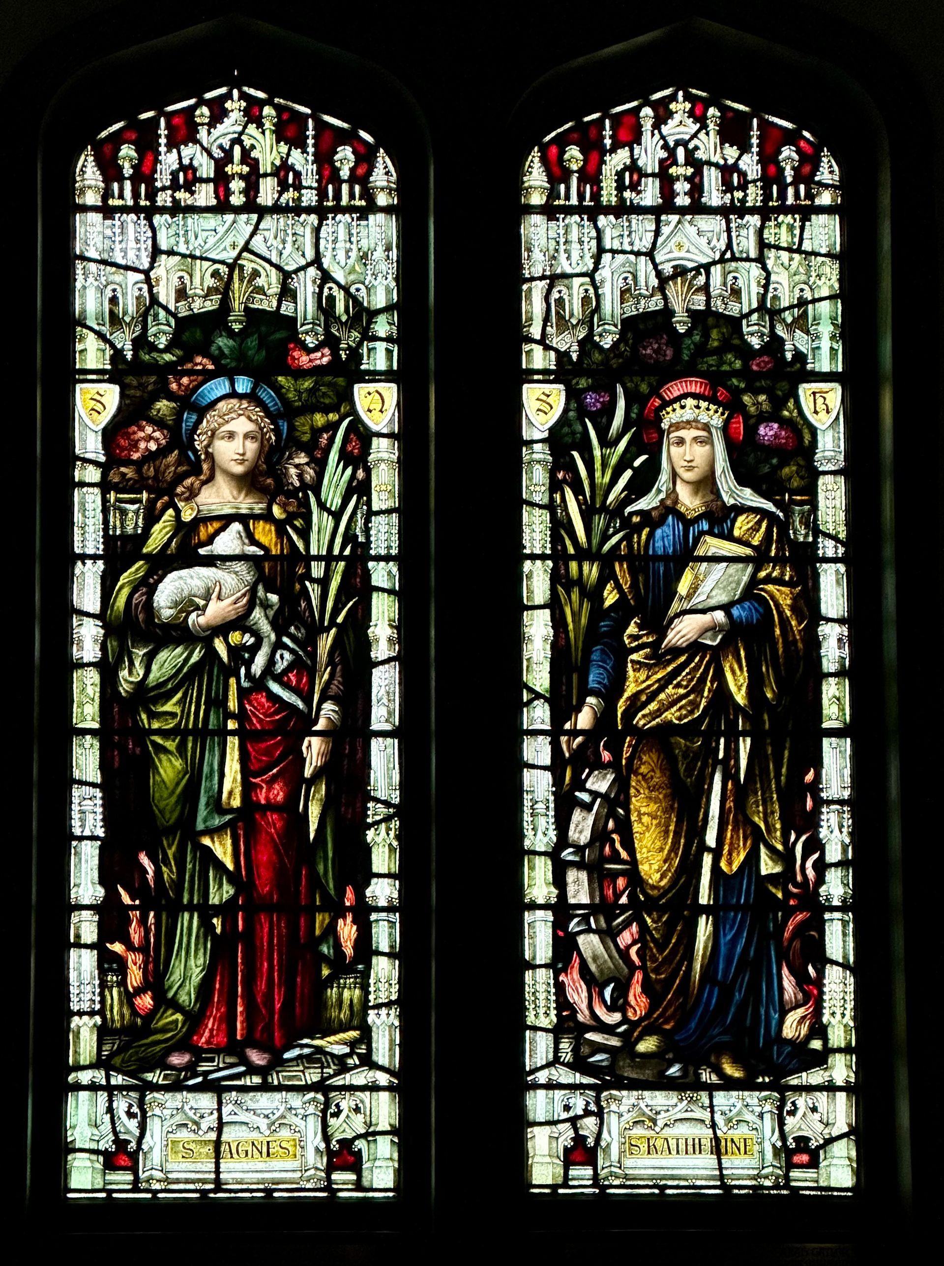 Stained glass church windows: Two figures in ornate robes, holding objects, with colorful details.