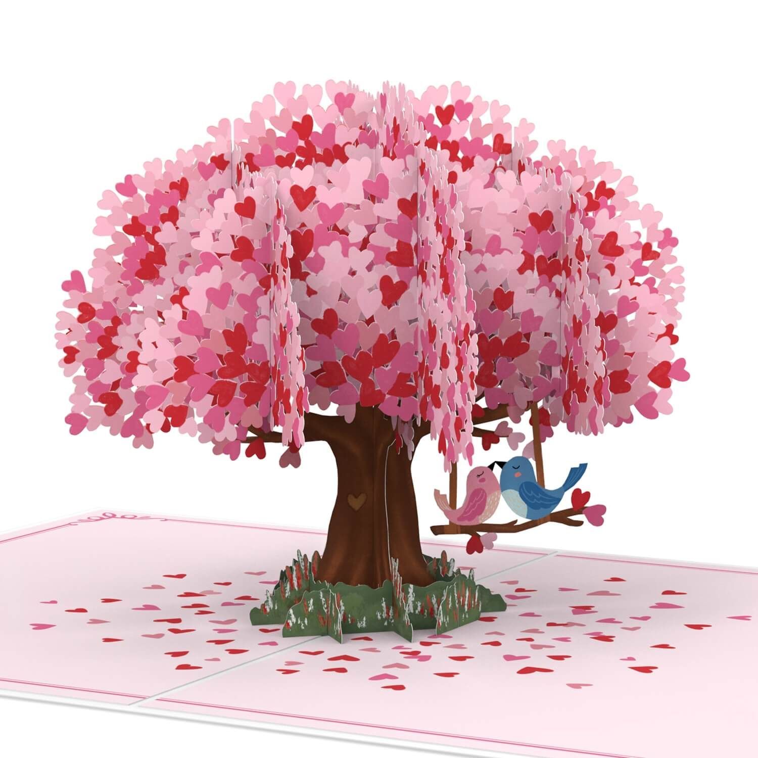 Roze bloeiende boom met een vogel op een schommel, bloemblaadjes verspreid over de grond.