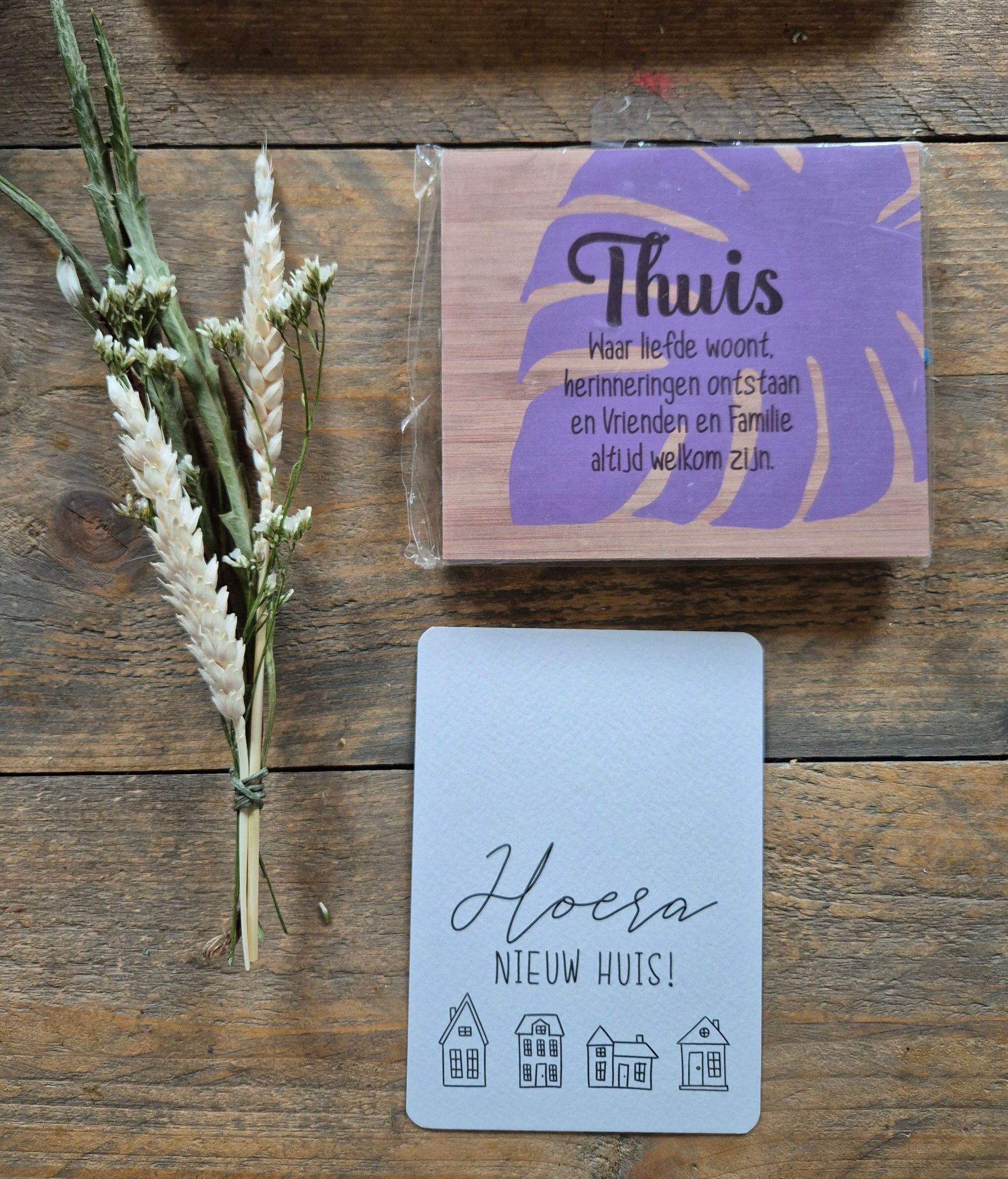 Two folded Dutch cards with flowers: one says “Hoera nieuw huis!”, the other “Thuis is …”