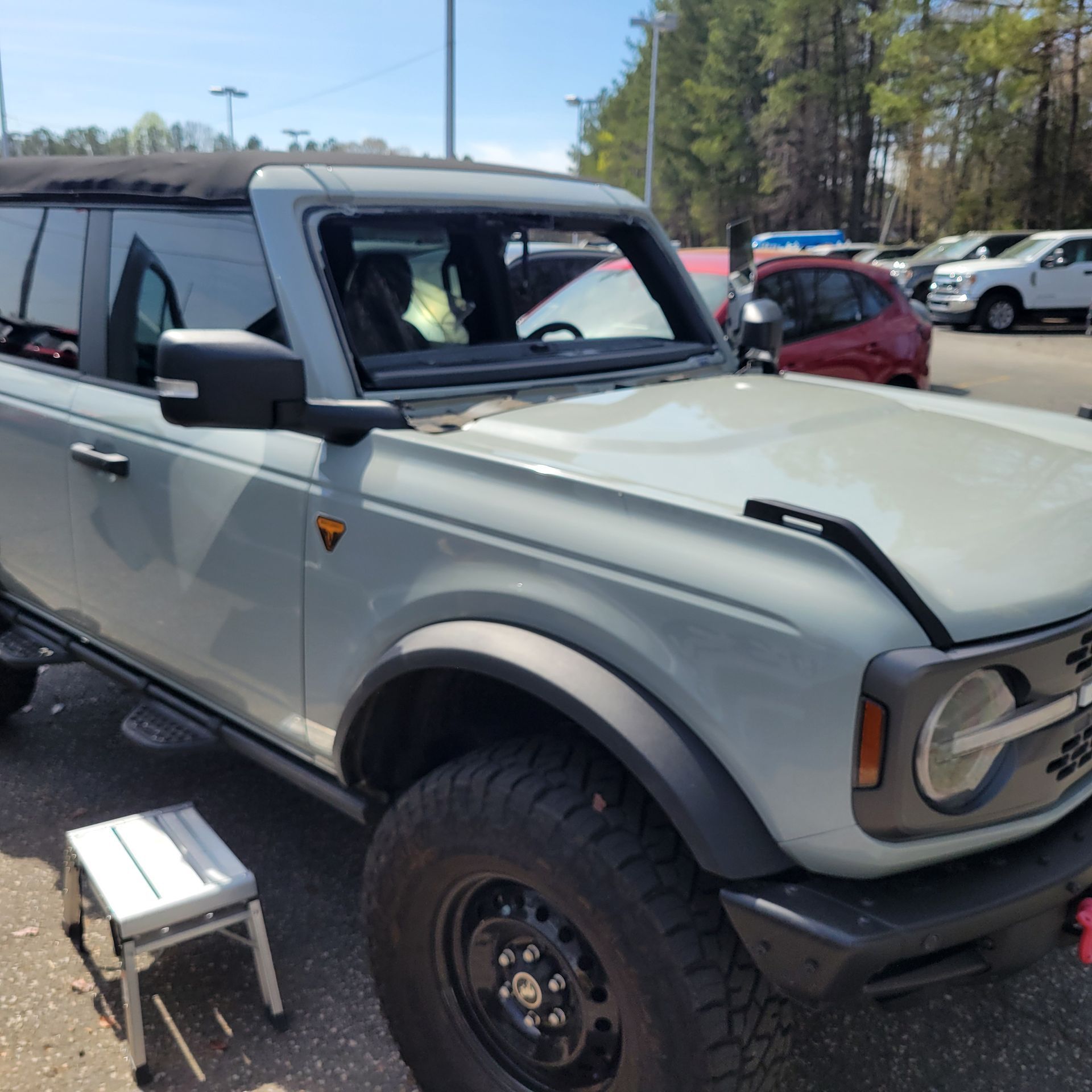 A gray Ford Bronco is parked in a parking lot