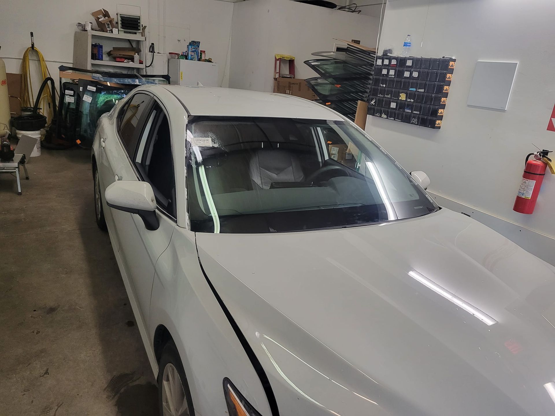 A white car is parked in a garage