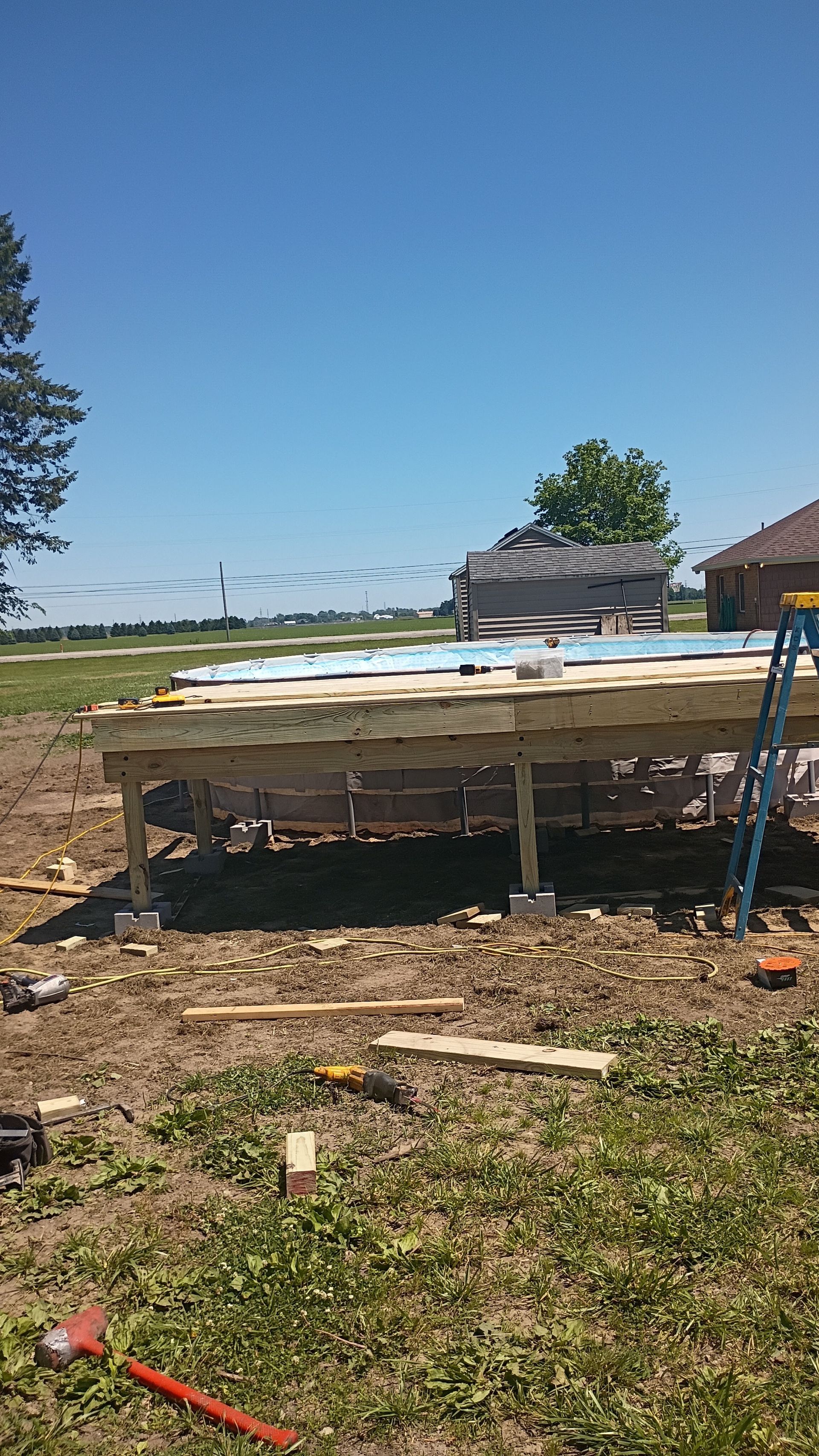 Makeshift wooden table with white materials in a dirt field under a clear blue sky