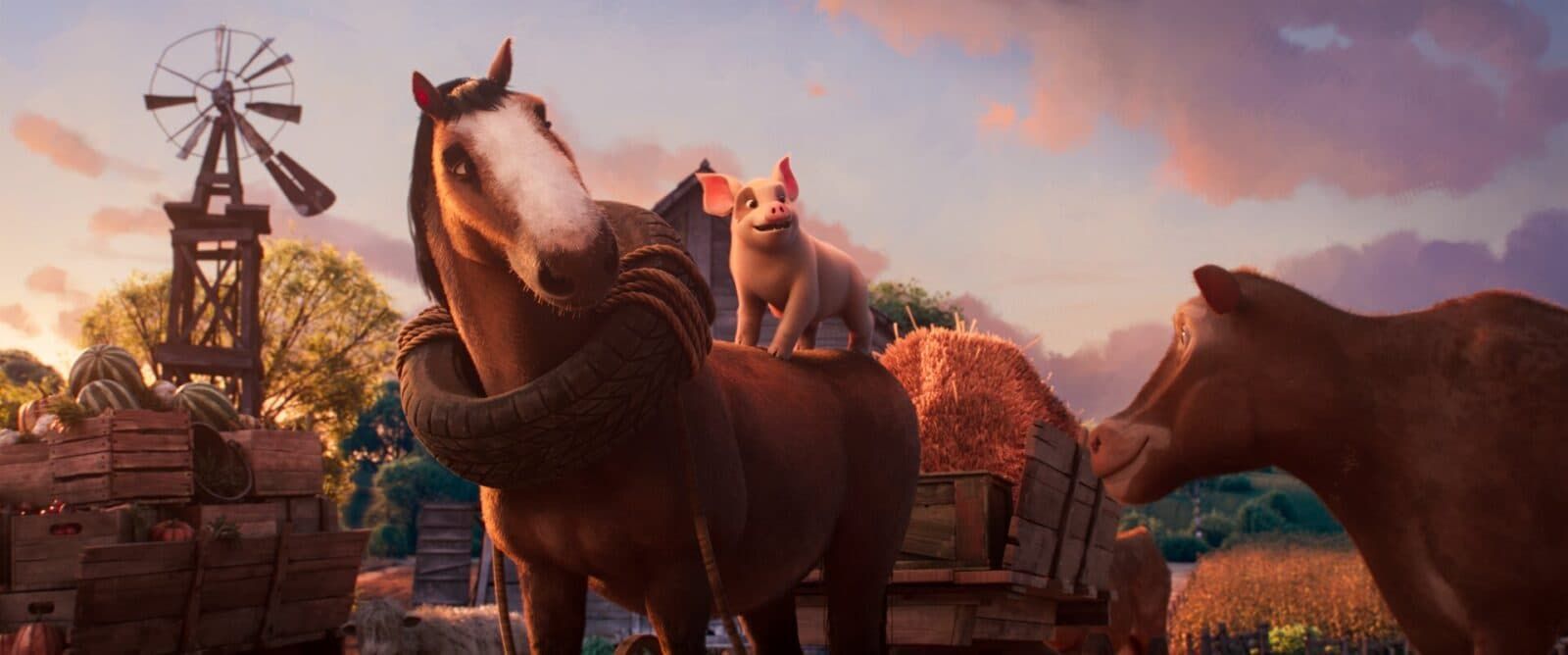Two horses in a rustic farm scene at sunset, with a windmill and mountains in the background