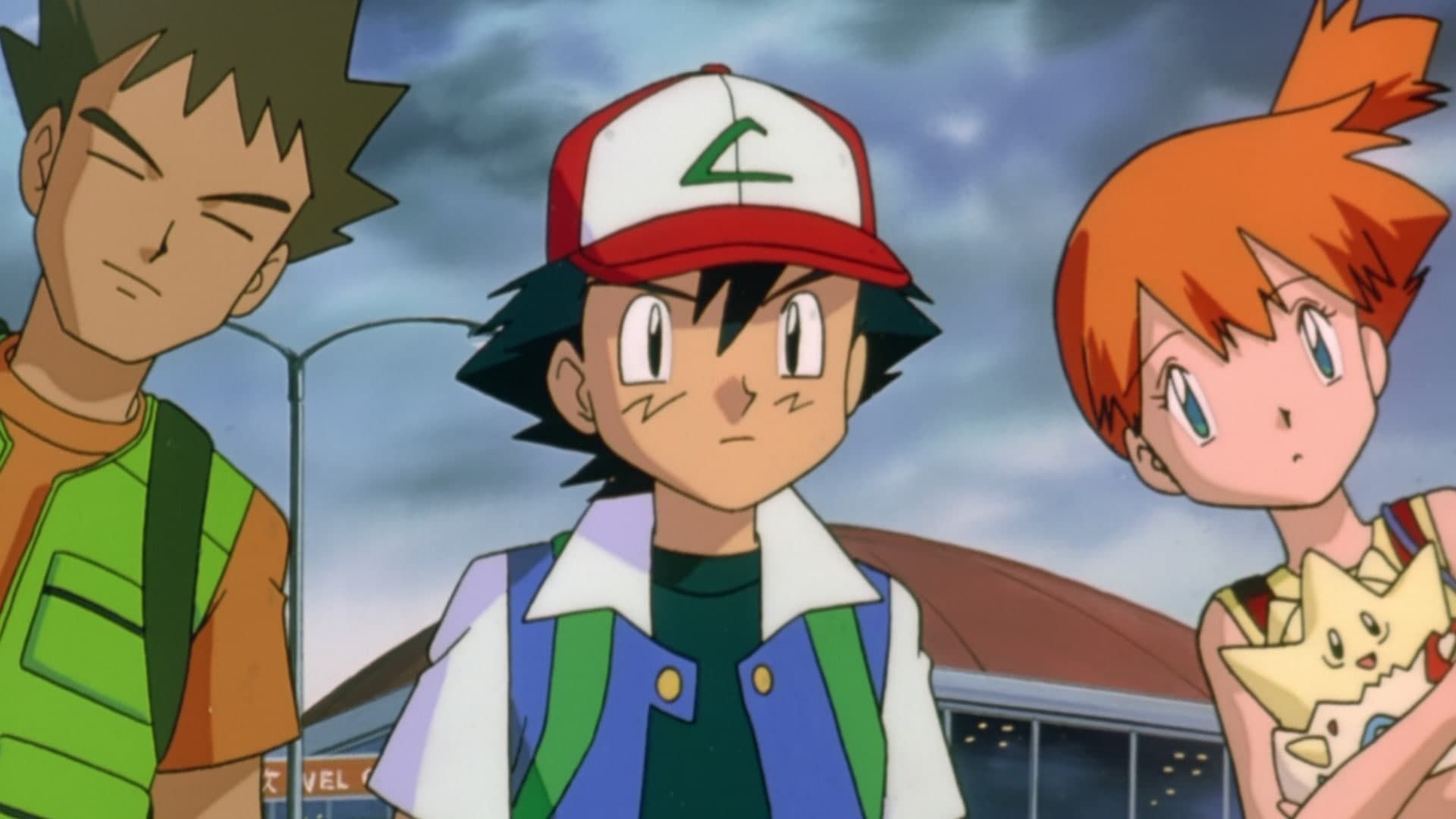Three anime characters standing outdoors: Ash in a cap, Brock with eyes closed, and Misty holding Togepi.