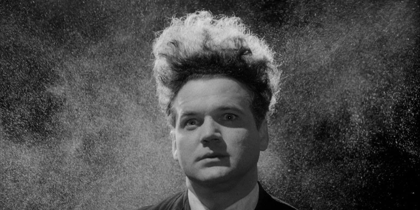 Black-and-white portrait of a stern-faced person with dramatic spiky hair against a dark background