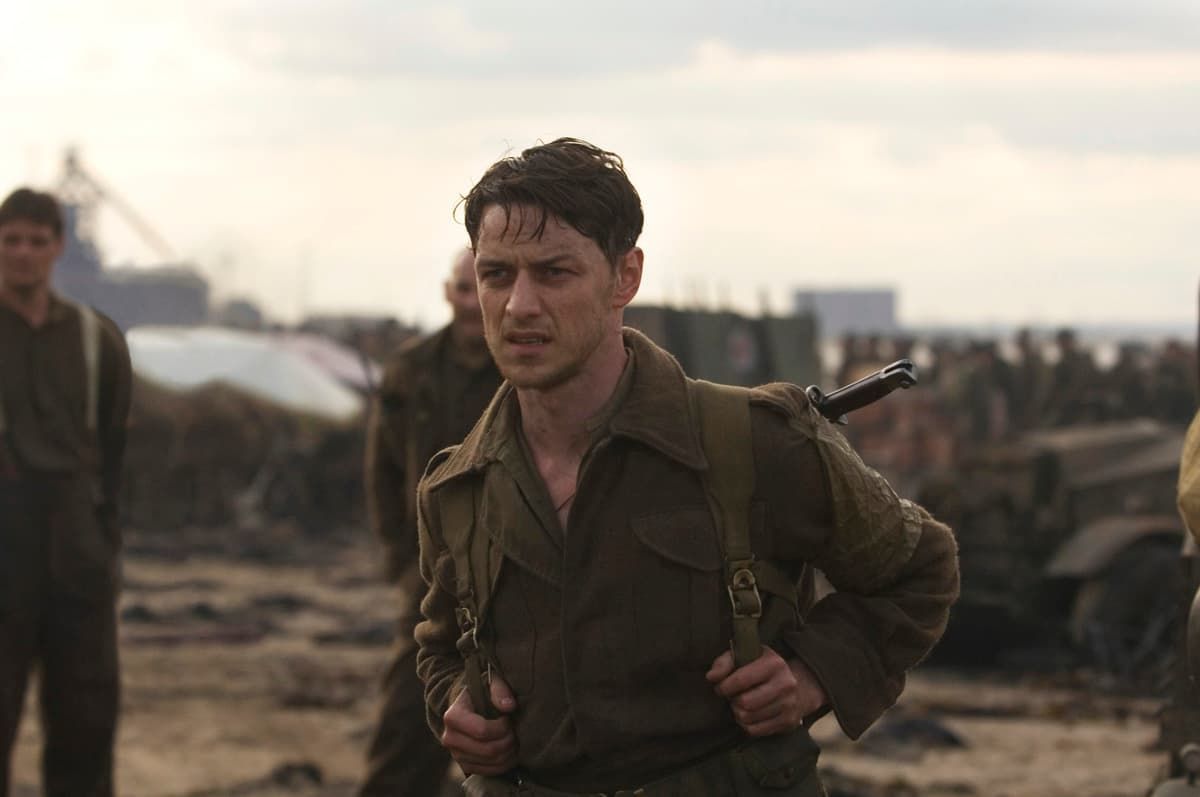 Soldier in muddy uniform carrying a rifle runs through a war-torn battlefield