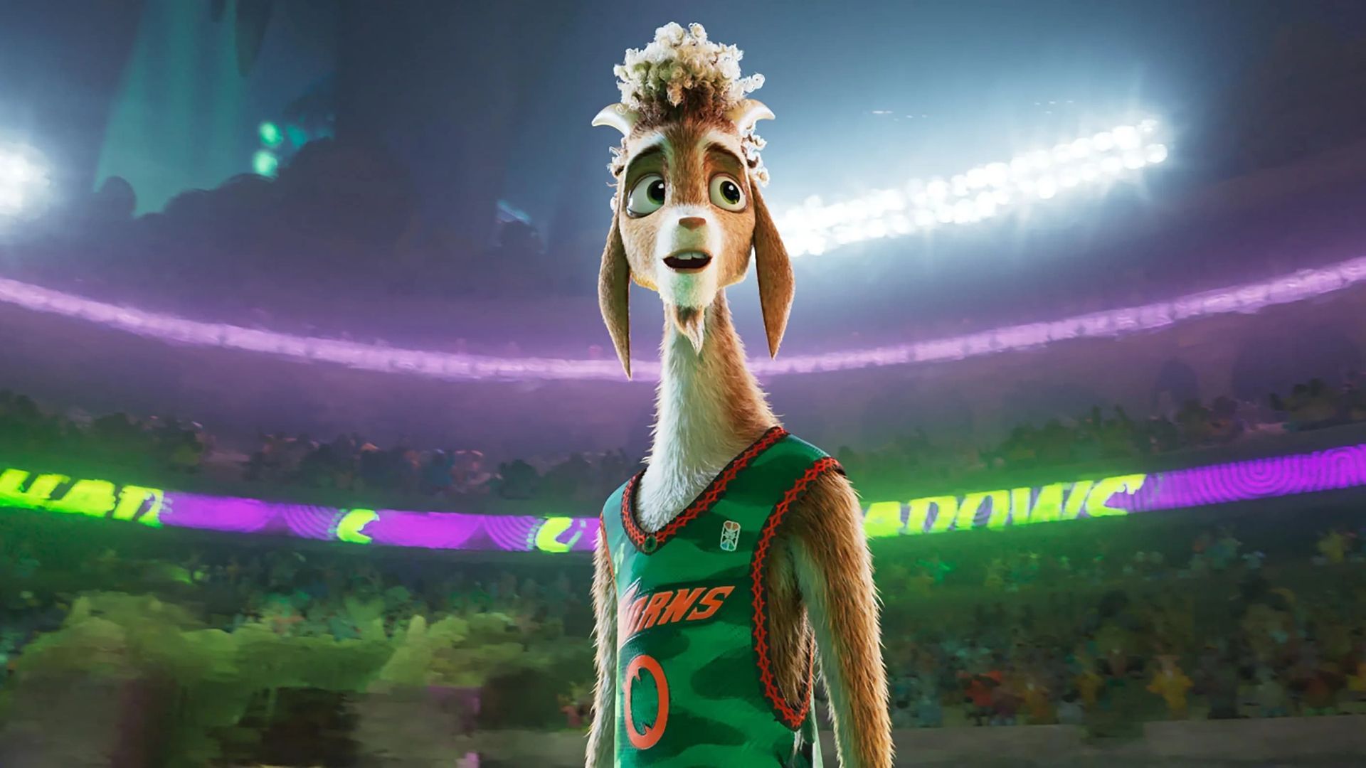 Llama in a green basketball jersey stands in a stadium, smiling. Purple and white lights illuminate the arena.