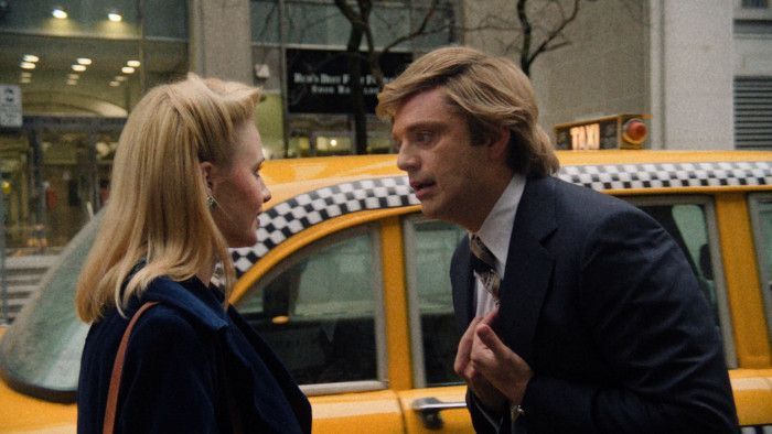 Blonde woman and man in suit talking 