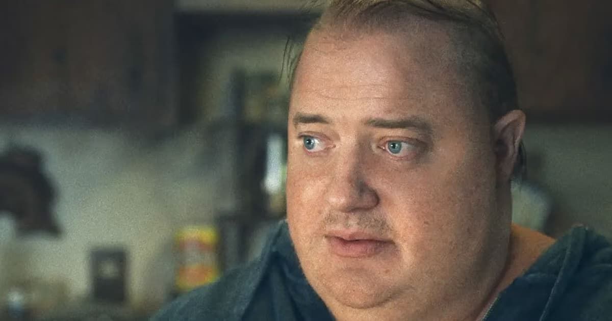 Close-up of a man in a dim kitchen, looking off to the side with a concerned expression