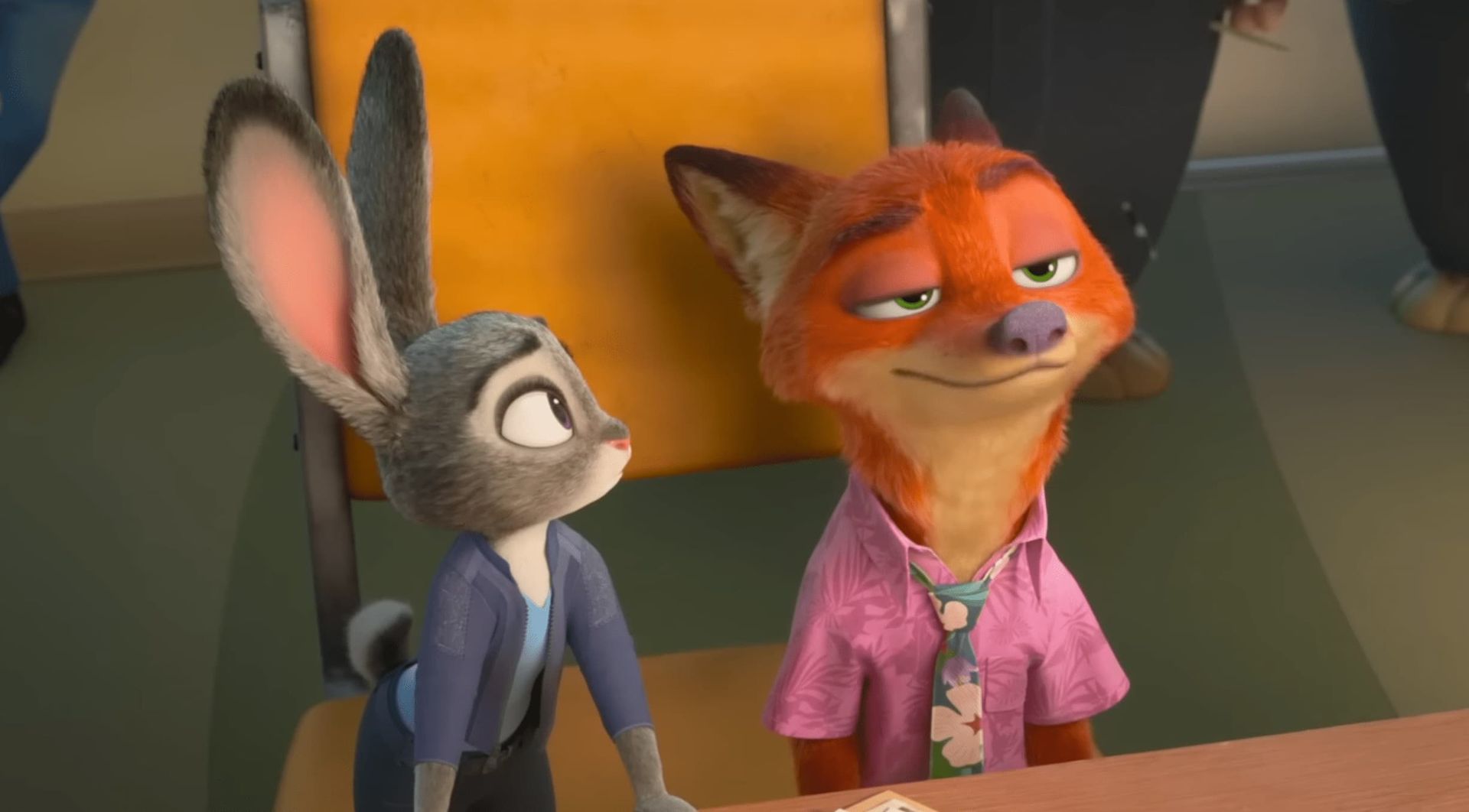 Animated fox and rabbit seated together, both looking upward in a classroom or theater setting.