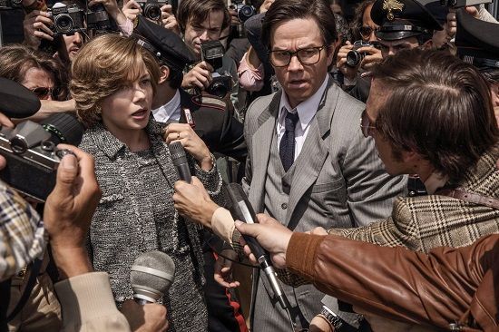 Reporters surround two people