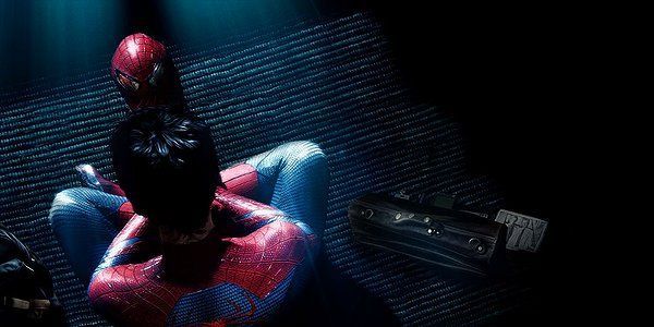 Spider-Man sits on a dark floor, facing away. Red and blue suit, with a red mask visible.