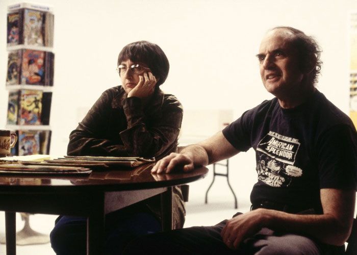 Two people sit at a round table