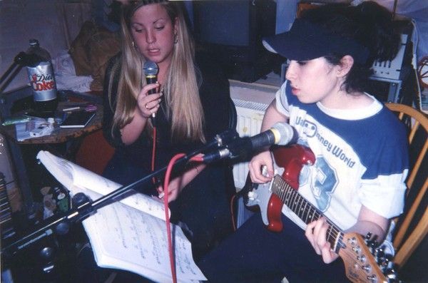 Two women rehearsing music.