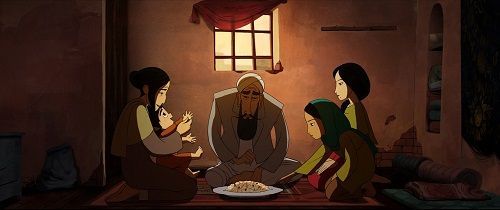 A family gathers indoors.