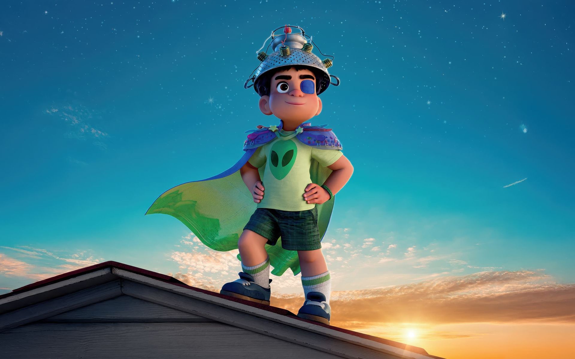Cartoon child superhero in green cape standing on a rooftop at sunset under a blue sky