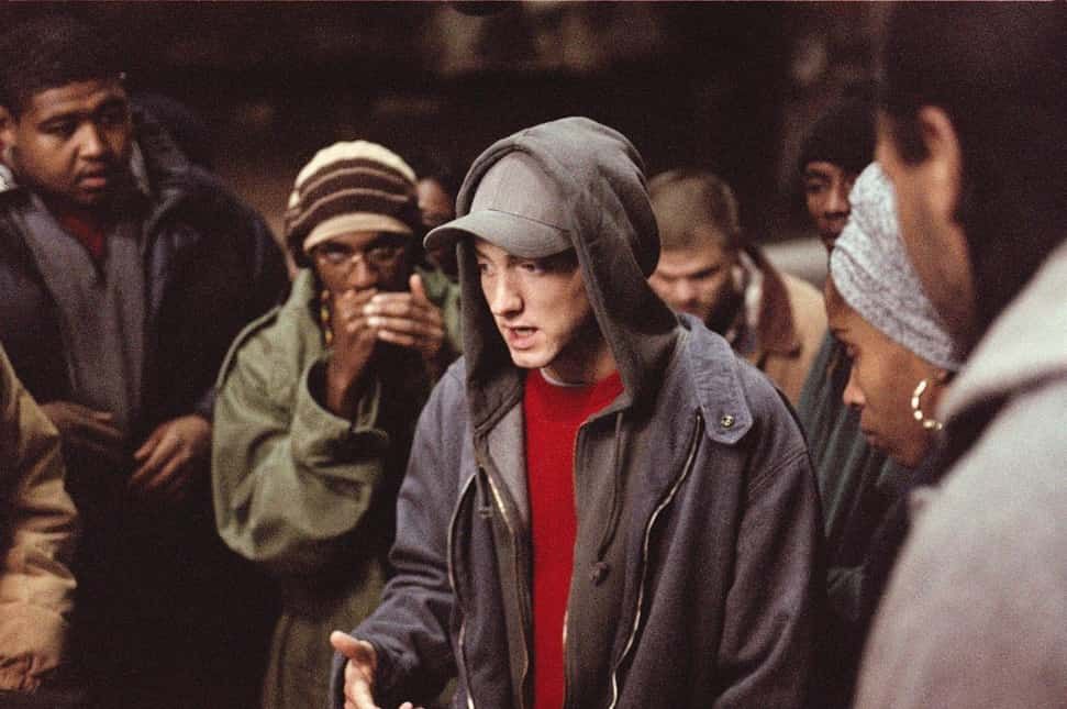 Eminem rapping, surrounded by people