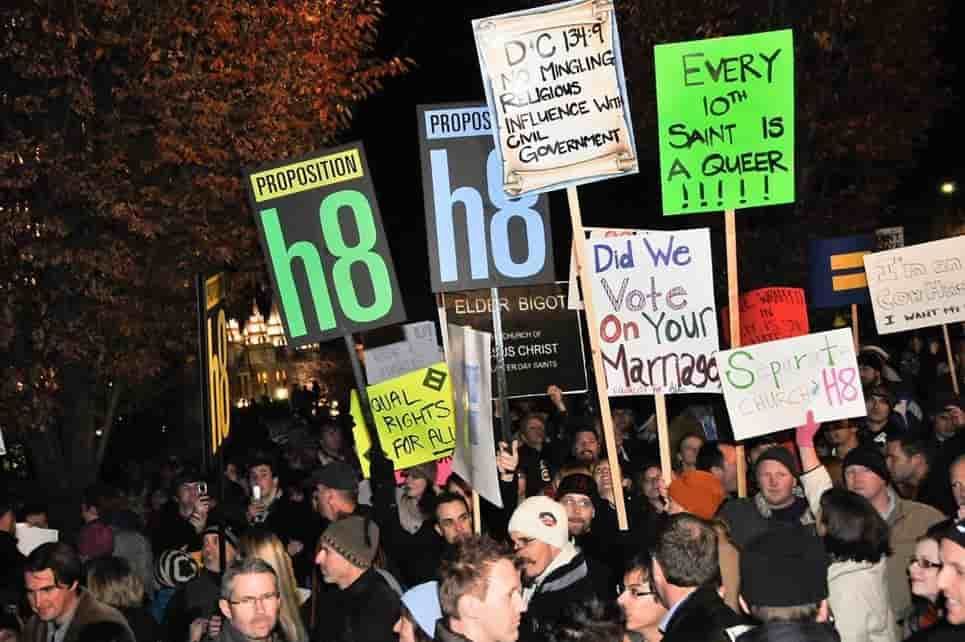 Protesters with signs against same-sex marriage at night. Signs use phrases like