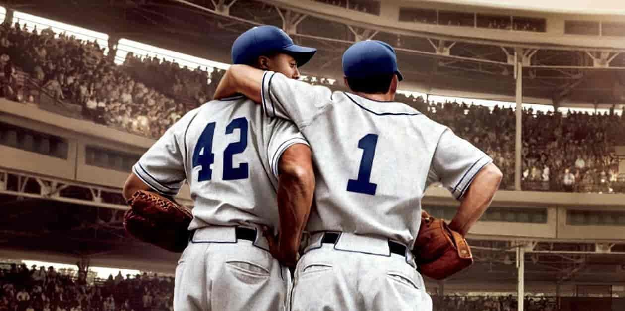 Two baseball players in vintage uniforms number 42