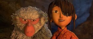 Animated boy and baboon standing side by side, both looking at the camera outdoors at dusk