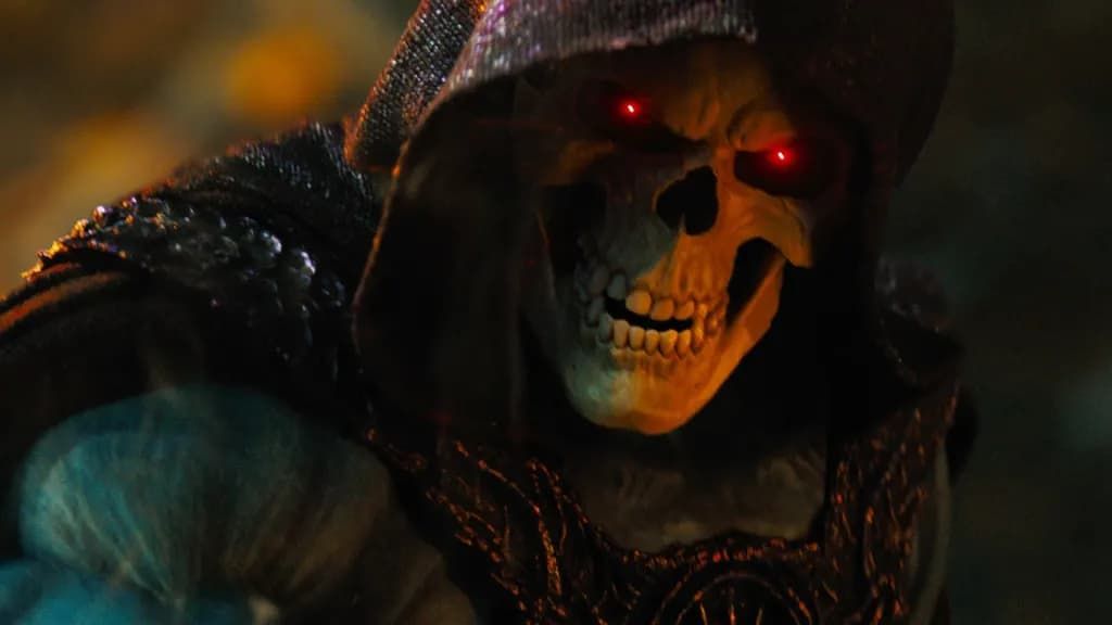 Cloaked skull with glowing red eyes in a dark, shadowy scene