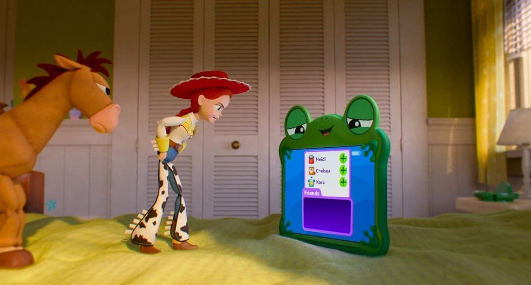 Toy horses and a cowgirl face a green tablet in a sunlit bedroom scene