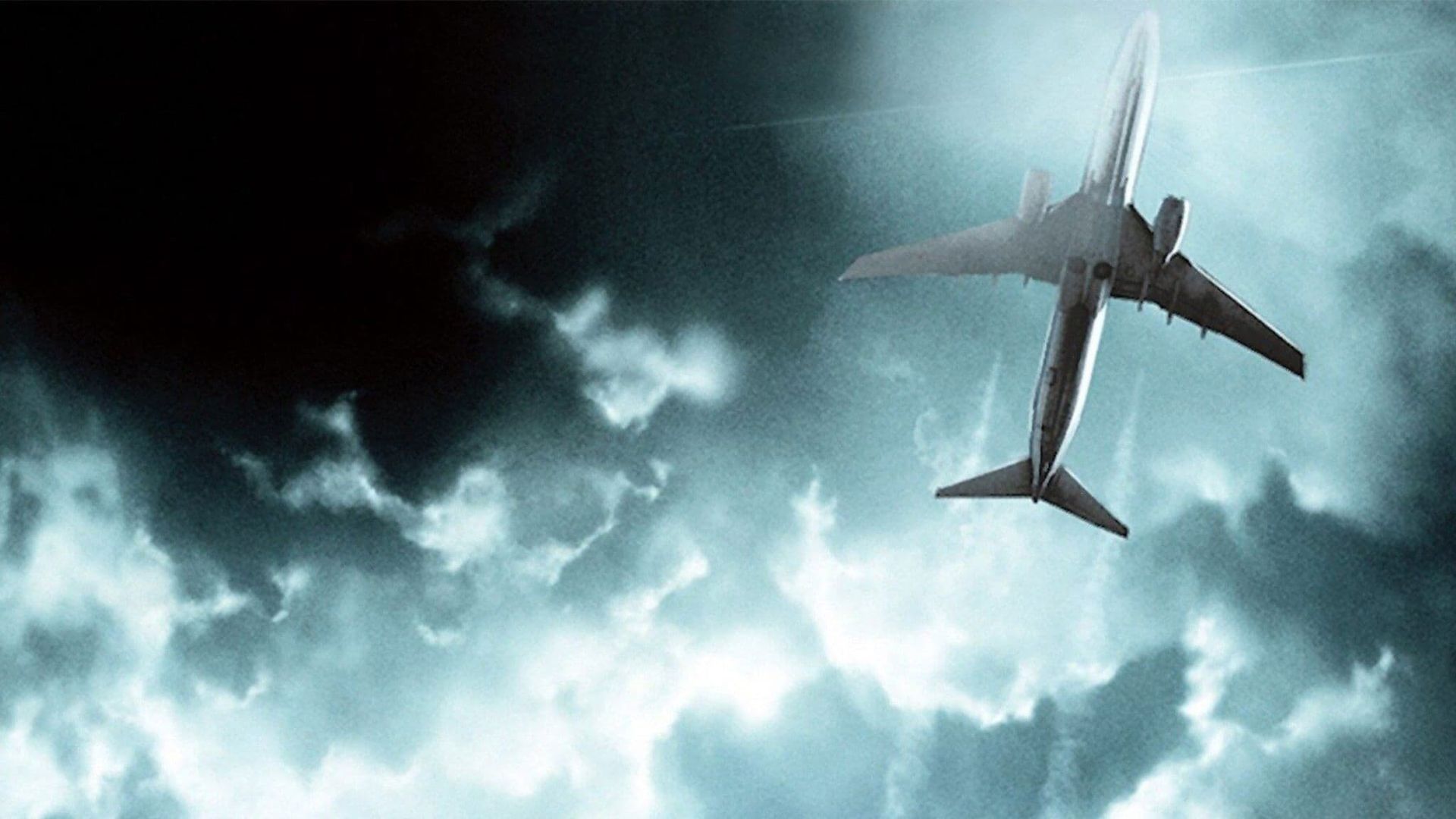 Airplane flying through dark storm clouds overhead